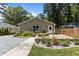 Home exterior showcases well-maintained landscaping, a brick patio, and a gravel border at 2712 Broad St, Durham, NC 27704
