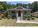 Charming single-story home showcasing a red door and lush landscaping at 2712 Broad St, Durham, NC 27704