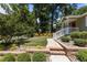 Charming home with a brick exterior, red door, white porch railing, and meticulously landscaped front yard at 2712 Broad St, Durham, NC 27704