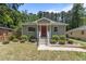 Charming single-story home showcasing a red door and lush landscaping at 2712 Broad St, Durham, NC 27704
