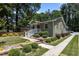 Charming home with a brick exterior, red door, white porch railing, and meticulously landscaped front yard at 2712 Broad St, Durham, NC 27704