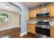 Kitchen with stainless steel oven and microwave, light wood cabinets, and granite countertops at 2712 Broad St, Durham, NC 27704