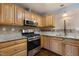 Spacious kitchen featuring light wood cabinets, stainless steel appliances, granite countertops, and tiled backsplash at 2712 Broad St, Durham, NC 27704