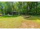 Expansive backyard with gazebo, patio, grill, and fire pit, ideal for outdoor entertaining and relaxation at 2721 Rustic Brick Rd, Raleigh, NC 27603