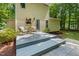 Backyard exterior with two chairs, small table and yellow vinyl siding at 2721 Rustic Brick Rd, Raleigh, NC 27603