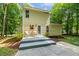 Backyard features a deck area with outdoor seating and a well-maintained yard surrounded by lush greenery at 2721 Rustic Brick Rd, Raleigh, NC 27603