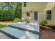 Backyard exterior with two chairs, small table and yellow vinyl siding at 2721 Rustic Brick Rd, Raleigh, NC 27603