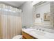 Bathroom features a mirror, a sink, a toilet, and a shower with curtain at 2721 Rustic Brick Rd, Raleigh, NC 27603