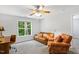 Bright room with a comfortable leather sofa and a window offering a lovely view of the outdoors at 2721 Rustic Brick Rd, Raleigh, NC 27603