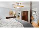 Stylish bedroom with a four-poster bed, warm lighting, and an open ensuite bathroom at 2721 Rustic Brick Rd, Raleigh, NC 27603