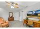 Bedroom featuring desk and seating area, ceiling fan, and large television at 2721 Rustic Brick Rd, Raleigh, NC 27603