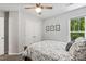 Bedroom features a closet, a ceiling fan, a window with view, artwork and wooden furniture at 2721 Rustic Brick Rd, Raleigh, NC 27603