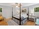 Cozy bedroom with wood floors, decorative furnishings, and plenty of natural light, creating a peaceful retreat at 2721 Rustic Brick Rd, Raleigh, NC 27603