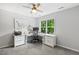 Bedroom with desk, ceiling fan, and a large window with outside view at 2721 Rustic Brick Rd, Raleigh, NC 27603