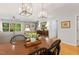 Charming dining room featuring wood floors, decorative lighting, and convenient access to the home's entryway and staircase at 2721 Rustic Brick Rd, Raleigh, NC 27603