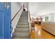 Open foyer with a staircase, hardwood floors, and views into the living room and kitchen at 2721 Rustic Brick Rd, Raleigh, NC 27603