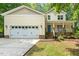 Charming yellow two-story home featuring a spacious garage, inviting porch, and well-manicured lawn at 2721 Rustic Brick Rd, Raleigh, NC 27603