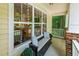 Inviting porch featuring a cozy bench with decorative pillows, ideal for relaxing and enjoying the outdoors at 2721 Rustic Brick Rd, Raleigh, NC 27603