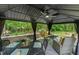 Inviting gazebo with elegant outdoor seating, ceiling fan, and views of the beautifully landscaped backyard at 2721 Rustic Brick Rd, Raleigh, NC 27603