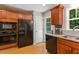 Updated kitchen featuring granite countertops, stainless steel appliances, and easy access to the backyard and dining area at 2721 Rustic Brick Rd, Raleigh, NC 27603