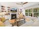 Bright living room with a fireplace, built-in bookshelves, large windows and comfortable seating at 2721 Rustic Brick Rd, Raleigh, NC 27603