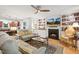 Inviting living room with a fireplace, built-in shelving, and hardwood floors at 2721 Rustic Brick Rd, Raleigh, NC 27603