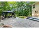 Spacious patio with outdoor dining area and gazebo, perfect for entertaining or relaxing, with a lush green backdrop at 2721 Rustic Brick Rd, Raleigh, NC 27603