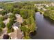 Aerial view of a home's backyard oasis by the lake, with a custom pool and lush greenery at 3004 Montville Valley Ct, Cary, NC 27519