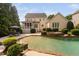 Backyard featuring a pool with waterfall, patio with seating, and screened porch at 3004 Montville Valley Ct, Cary, NC 27519