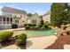 Backyard oasis with pool, waterfall feature, lush landscaping and comfortable lounge area at 3004 Montville Valley Ct, Cary, NC 27519