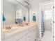 Bathroom with double sink vanity, large mirror, and a doorway leading to a shower at 3004 Montville Valley Ct, Cary, NC 27519