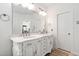 Elegant bathroom with a double vanity, marble countertop, and decorative white cabinetry at 3004 Montville Valley Ct, Cary, NC 27519