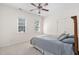 Cozy bedroom features a ceiling fan, plush carpet, and ample natural light from two windows at 3004 Montville Valley Ct, Cary, NC 27519