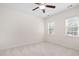 Well-lit bedroom with neutral carpet, ceiling fan, and double windows at 3004 Montville Valley Ct, Cary, NC 27519