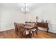 Formal dining room featuring hardwood floors, wainscoting, and decorative chandelier at 3004 Montville Valley Ct, Cary, NC 27519