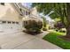 Charming home featuring light yellow siding, a balcony, attached garage, and beautiful landscaping at 3004 Montville Valley Ct, Cary, NC 27519
