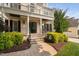 Beautiful home featuring a stone facade, welcoming porch, and manicured landscaping at 3004 Montville Valley Ct, Cary, NC 27519