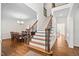 Grand foyer with hardwood floors connects dining room and staircase with wrought iron spindles at 3004 Montville Valley Ct, Cary, NC 27519