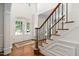 Grand foyer featuring hardwood floors, staircase with wrought iron spindles, and natural light at 3004 Montville Valley Ct, Cary, NC 27519