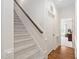Hallway featuring carpeted stairs and wood flooring at 3004 Montville Valley Ct, Cary, NC 27519