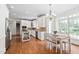 Bright kitchen with white cabinetry, stainless steel appliances, a kitchen island, and a breakfast nook at 3004 Montville Valley Ct, Cary, NC 27519