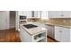 Close up of island with granite countertops and stainless steel appliances at 3004 Montville Valley Ct, Cary, NC 27519