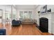 Elegant living room featuring hardwood floors, fireplace, and large windows for natural light at 3004 Montville Valley Ct, Cary, NC 27519