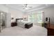 Spacious bedroom featuring tray ceilings, a ceiling fan, and lots of natural light at 3004 Montville Valley Ct, Cary, NC 27519