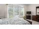 Bright bedroom showcasing large windows, patterned bedding, and stylish decor at 3004 Montville Valley Ct, Cary, NC 27519