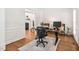 Bright office space featuring hardwood floors, wainscoting and an open doorway to the living room at 3004 Montville Valley Ct, Cary, NC 27519
