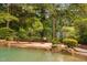 View of a custom pool featuring rock accents and lush landscaping for a serene outdoor space at 3004 Montville Valley Ct, Cary, NC 27519