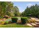 Backyard pool with rock features, lush landscaping, and a seating area offers a private retreat at 3004 Montville Valley Ct, Cary, NC 27519