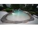 Backyard pool with a rock surround and built-in waterfall feature at 3004 Montville Valley Ct, Cary, NC 27519