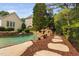 Beautiful backyard pool featuring a rock waterfall feature and lush landscaping at 3004 Montville Valley Ct, Cary, NC 27519